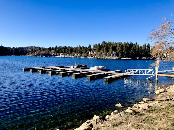 A deep blue lake with boat slips is Lake Arrowhead California