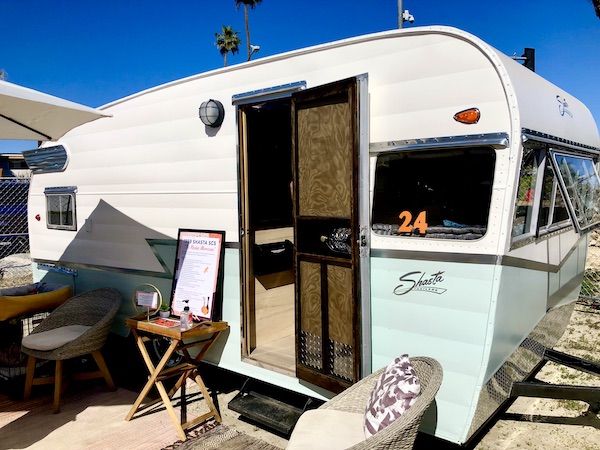 An old camper from the 50s in white and mint at the Palm Springs CA Vintage Trailer Show