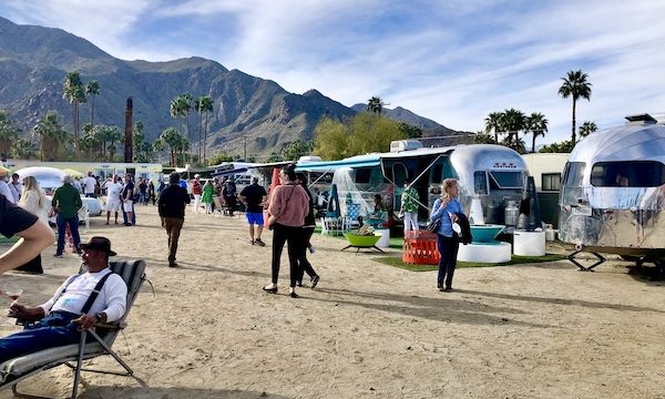 A camper show area with people, campers and mountains at the Palm Springs CA Vintage Trailer Show