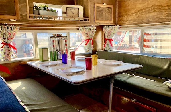 A camper dinette set with colored tumblers and a juke box!