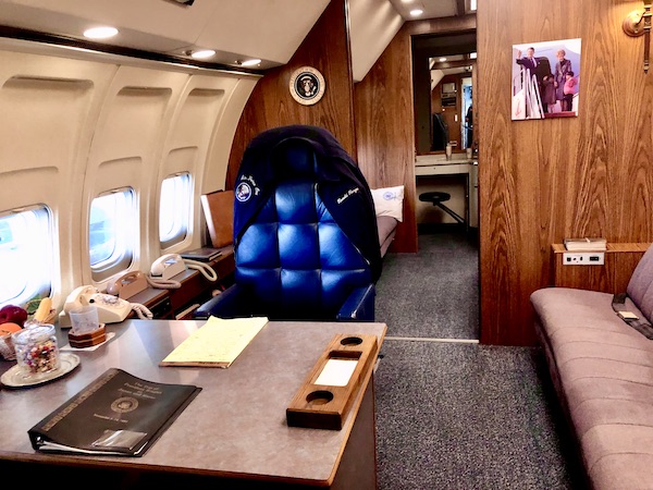 A desk, office chair and jacket aboard an airplane at the Ronald Reagan Presidential Library