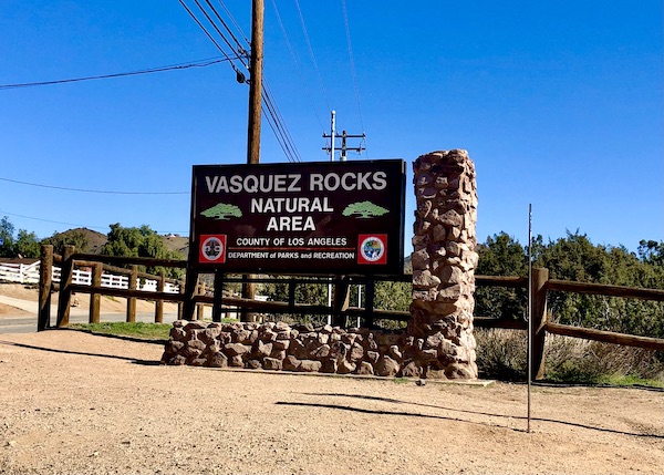 A brown sign welcoming you to Vasquez Rocks