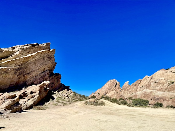 A wild west looking area with rocks, sand and blue sky at Vasquez Rocks Agua Dulce CA