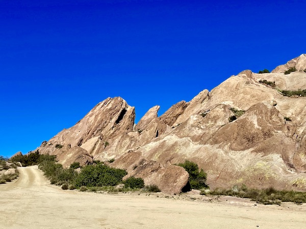 Eerie looking rocks and sand with deep blue sky