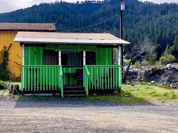 A green building with a front porch on our tour of the California Northern Coast Part I 
