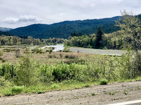 Dirt road, greenery a meandering river and mountains on the California Northern Coast Part I