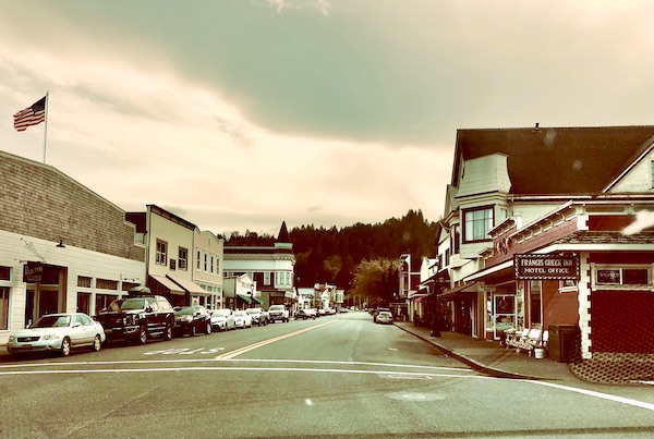 A main street lined with Victorian buildings and parked cars in California Northern Coast Part II