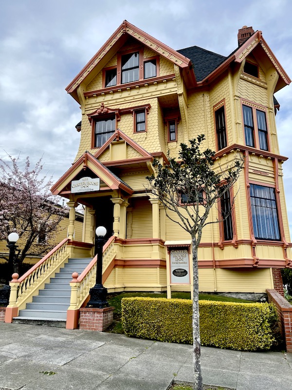 A butter yellow and maroon Victorian building along the California Northern Coast Part II