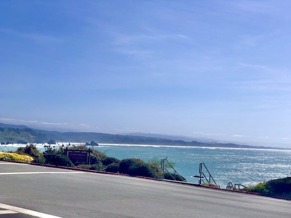 A road passing the ocean with mountains in the distance along the California Northern Coast Part II