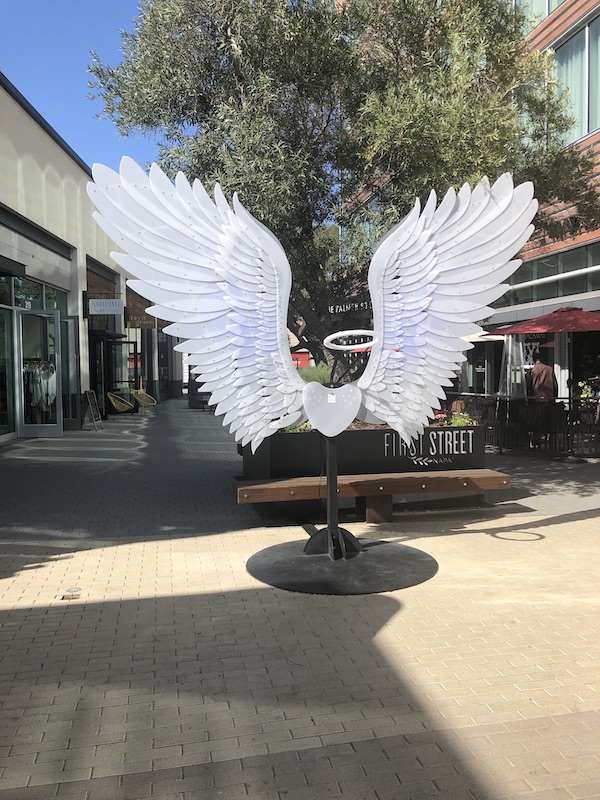 White sculpture if angel wings with heart and halo seen while having Fun in Downtown Napa CA