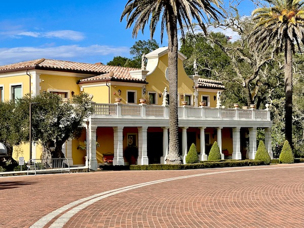 A yellow and white building with columns and balcony on our Napa Valley Winery Tour