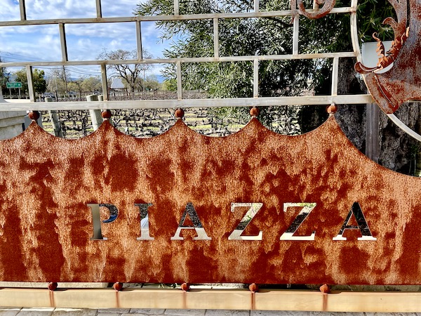 A rusted entry gate with "piazza" cut out on our Napa Valley Winery Tour
