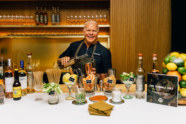 A man pouring tequila into cocktail glasses from The Tequila Diet by Chef Dave Martin