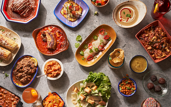 A table topped with many dishes of food from The Tequila Diet by Chef Dave Martin