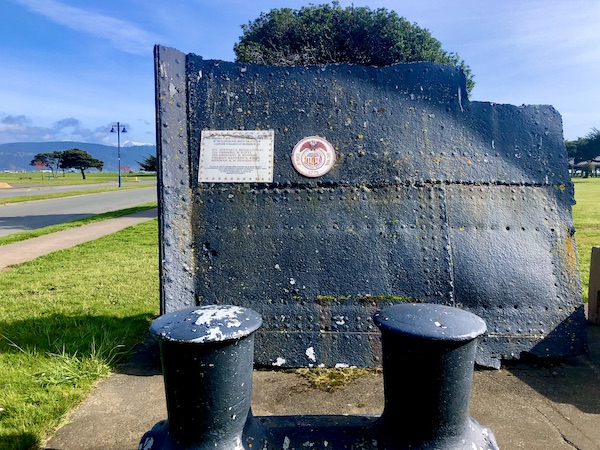 A piece of a black ship hull pays honor to fallen sailors in Crescent City California