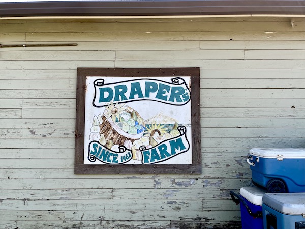 Sign on the wall of a wood structure lets you know you're at Draper's Girls Farm