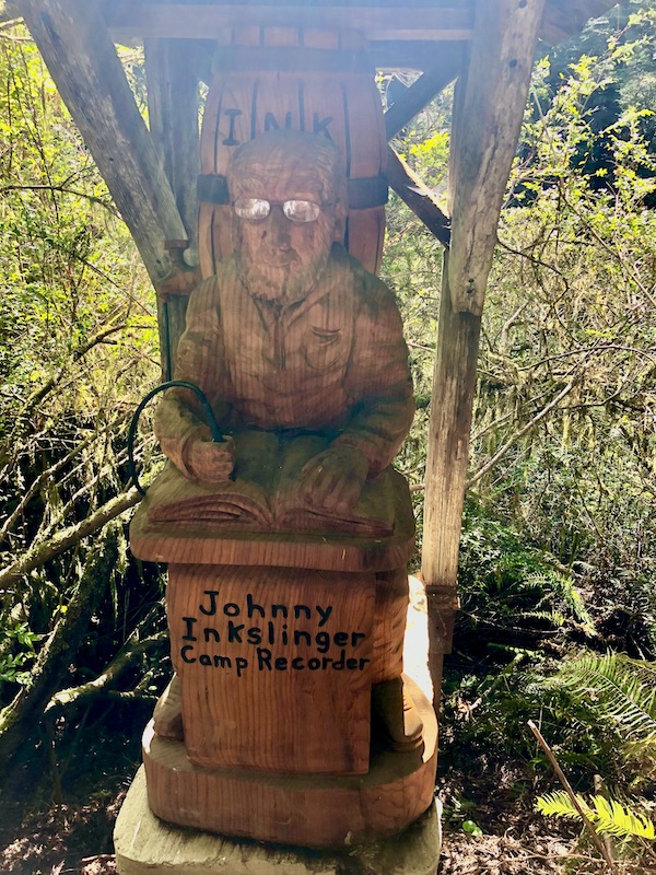 A carved wood sculpture of a man with glasses at Trees of Mystery Klamath CA