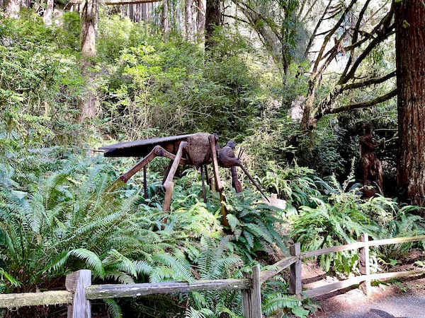Giant carved wood mosquito sculpture set in the woods at Trees of Mystery Klamath CA