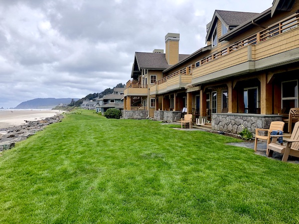 A row of wood beach houses on a grassy hill in Cannon Beach Oregon