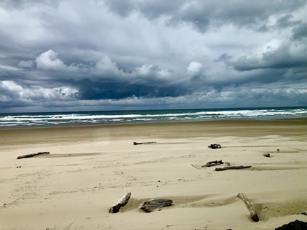 Sandy beach with ocean and storm clouds at Cannon Beach Oregon
