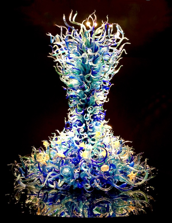 Blue, green and yellow glass tower at the Chihuly Gardens Seattle WA