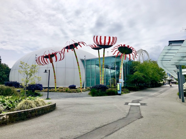 Huge whimsical metal flowers taller that building at Seattle Center near Chihuly Gardens Seattle WA