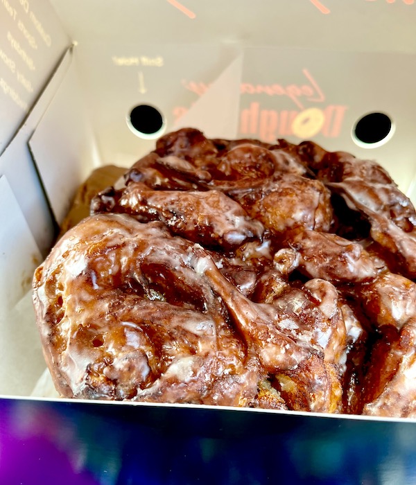 Inside a white pastry box with a huge apple fritter from Legendary Doughnuts Tacoma WA