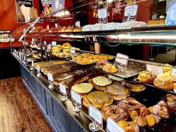 A glass pastry case filled with assorted donuts at Legendary Doughnuts Tacoma WA