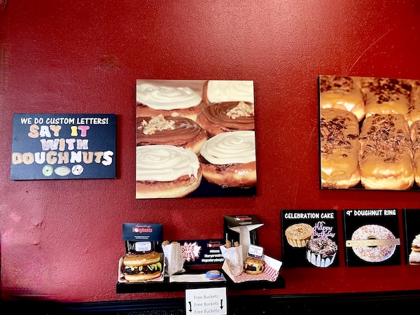 A red wall with photos of donuts at Legendary Doughnuts Tacoma WA