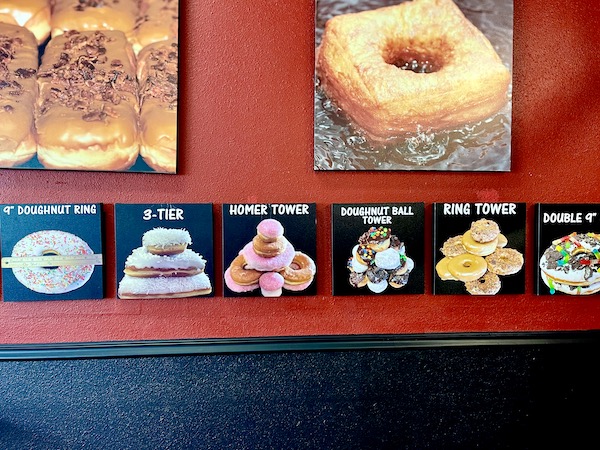 Photos of donuts on the red walls inside Legendary Doughnuts Tacoma WA
