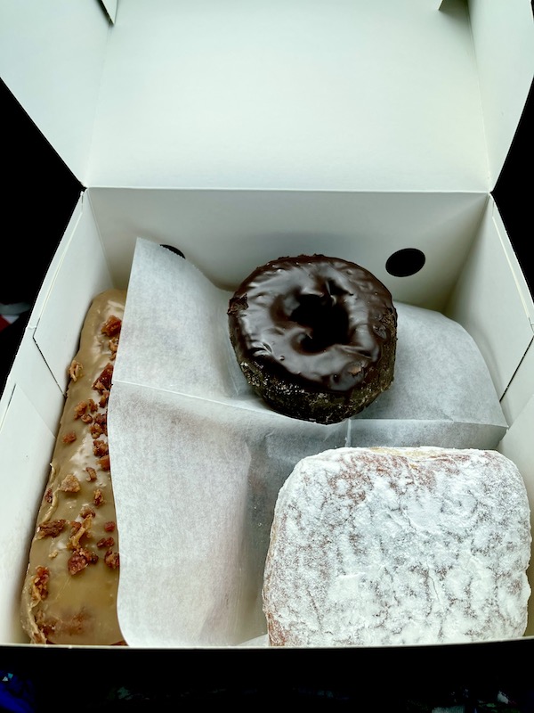 Inside a white box revealing 3 different donuts from Legendary Doughnuts Tacoma WA