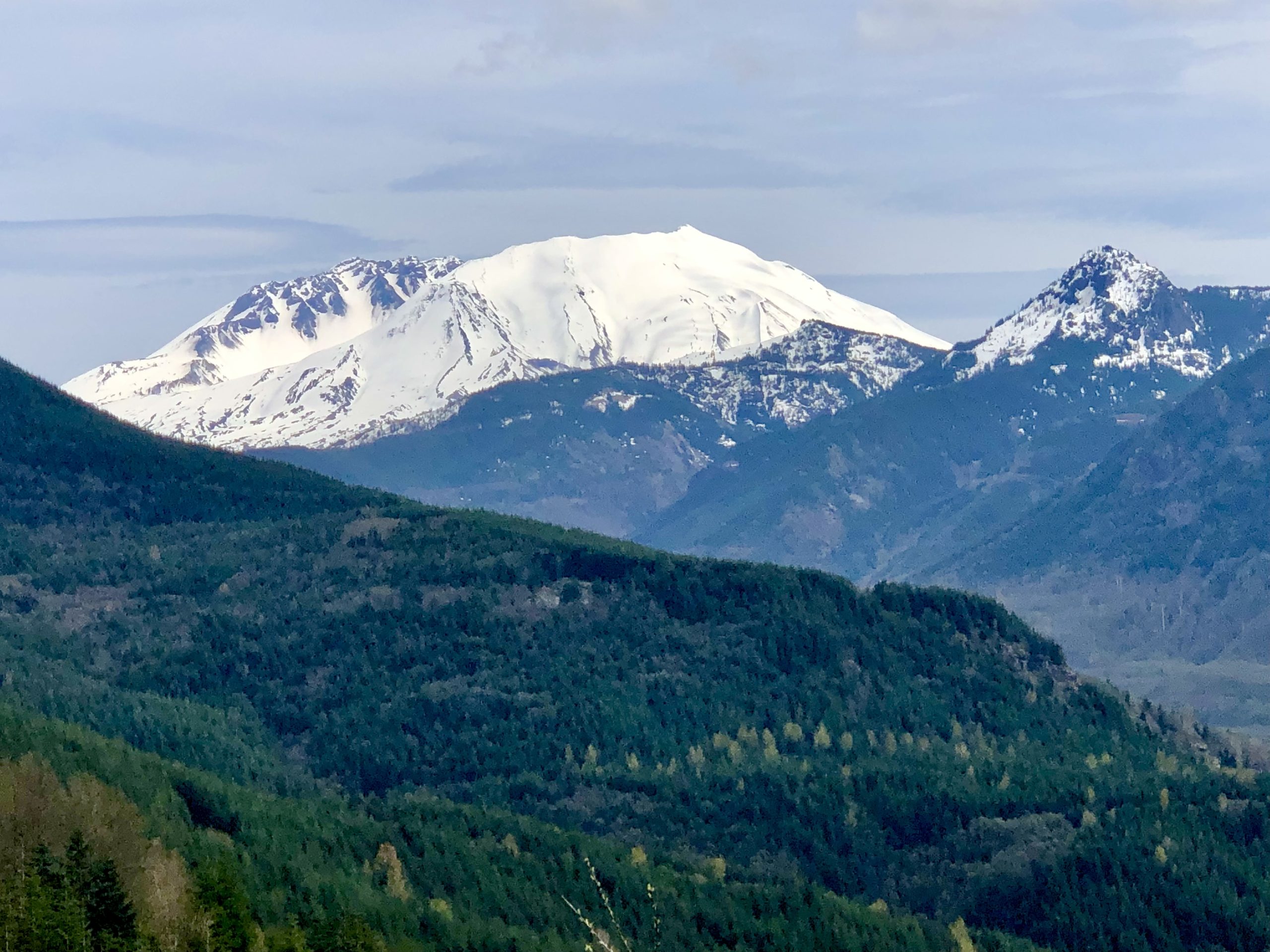 Snow capped volcanic mountain and mountain range at Mount St. Helens Washington
