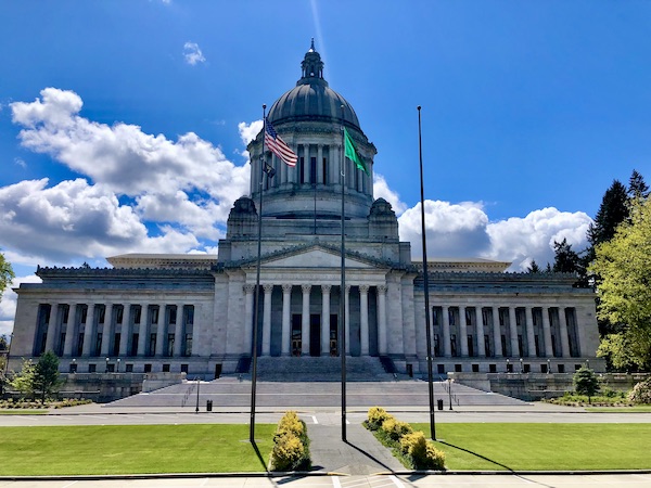 Large white building with columns and dome is the capitol in Olympia WA