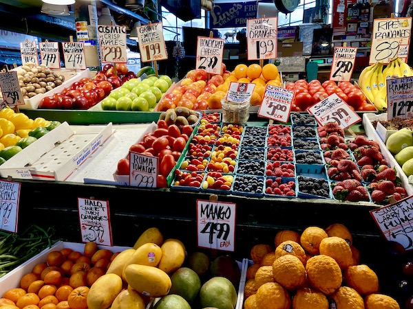 A farm stand with assorted fruit on display at Pike Place Market Seattle WA