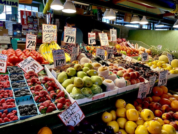 Farm stand with colorful fruit for sale at Pike Place Market Seattle WA