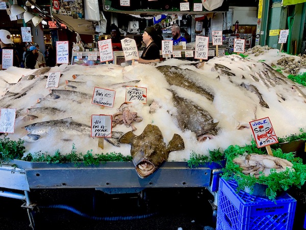A fish market with fresh fish on ice at Pike Place Market Seattle WA