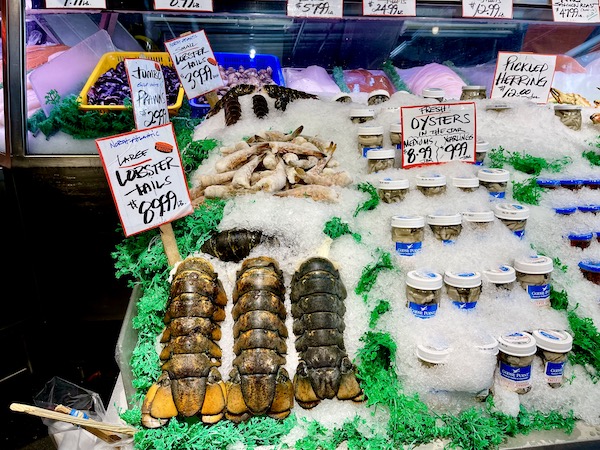 Assorted seafood on ice including lobster tails at Pike Place Market Seattle WA