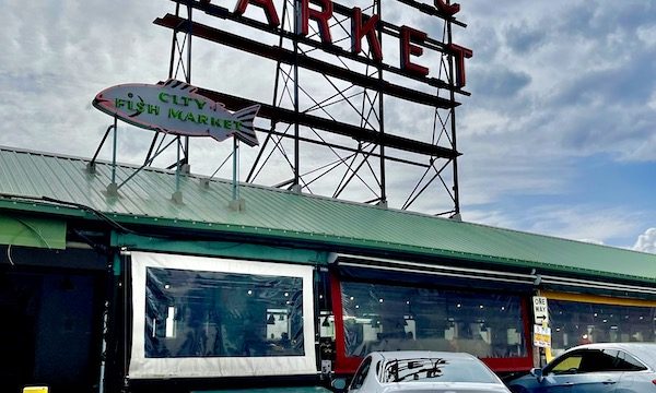 A metal grid with red letter Public Market on the green roof of Pike Place Market Seattle WA