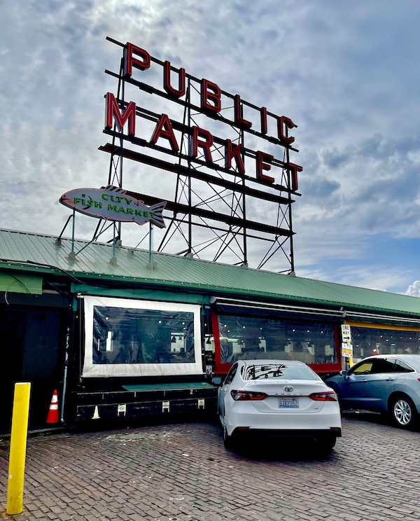 A metal grid with red letter Public Market on the green roof of Pike Place Market Seattle WA