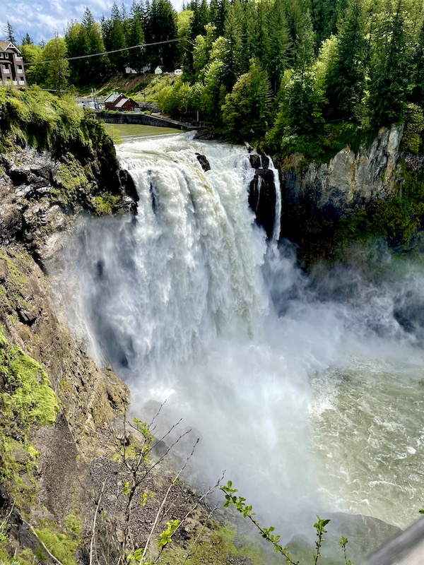A rushing waterfall, rocks and river known as Snoqualmie Falls Washington