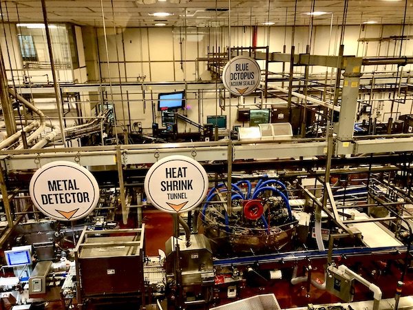 In the center of the factory floor is a big blue octopus vacuum sealer