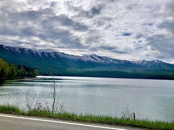 A still mountain lake with mountains in the background in Glacier National Park Montana