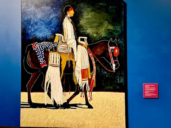 A painting of a Crow warrior on horseback at the museum of the rockies