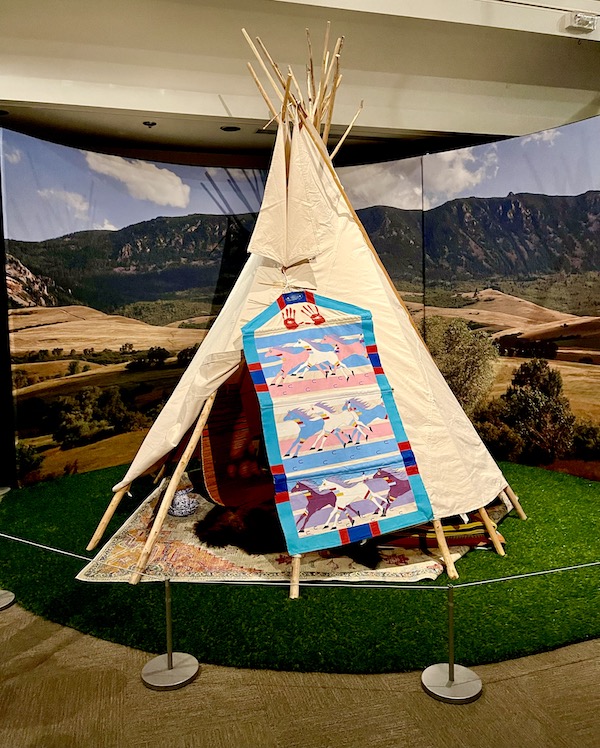 A tipi with flap open to show interior at the Museum of the Rockies Bozeman MT