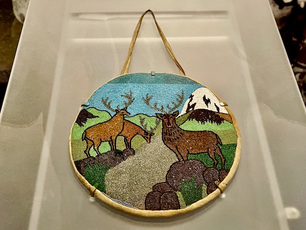 A round beaded bag depicting wildlife, land, sea and mountains at the Museum of the Rockies Bozeman MT