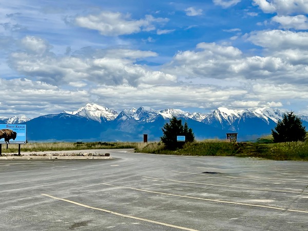 View of the snow-capped Rocky Mountains from the parking lot of the National Bison Range Montana