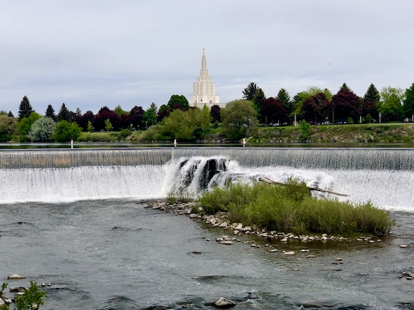 Snake River, waterfalls, trees and white church in distance seen during Our Day in Idaho Falls ID