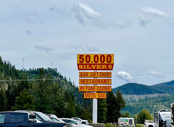 Yellow and red sign for 50,000 Silver Dollar Casino and Inn driving from Spokane WA to Coram Montana