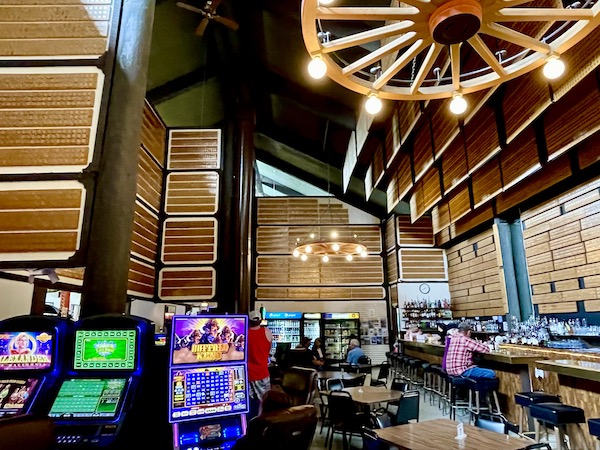 Inside a saloon with wagon wheel chandeliers, slot machines and silver dollars everywhere on our route from Spokane WA to Coram Montana