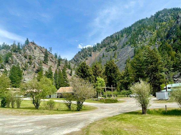 Mountains and forest with cabins and road en route from Spokane WA to Coram Montana